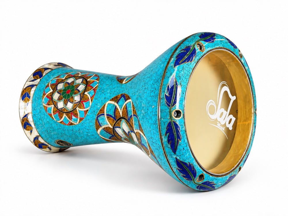 Sala Turquoise Lotus Sombaty darbuka on its side, showing the Sala-branded drumhead and turquoise-colored mosaic and layered floral medallions.